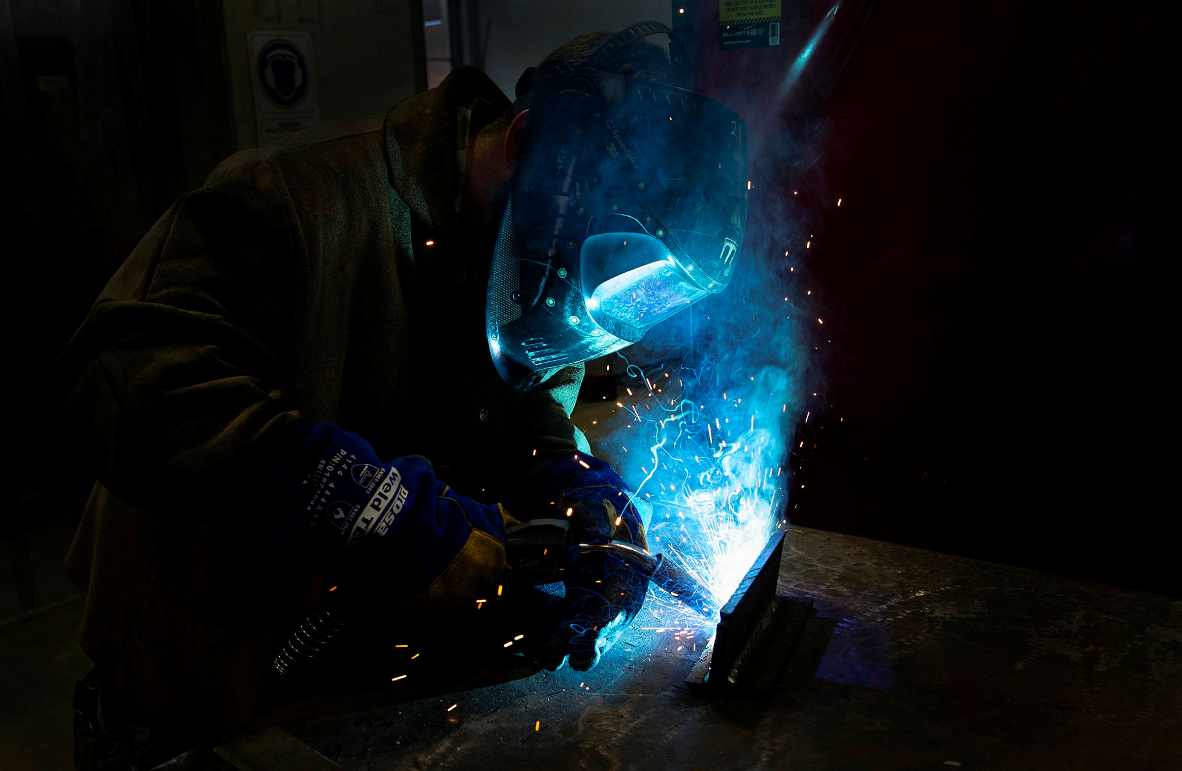 Person in welding safety gear welding steel