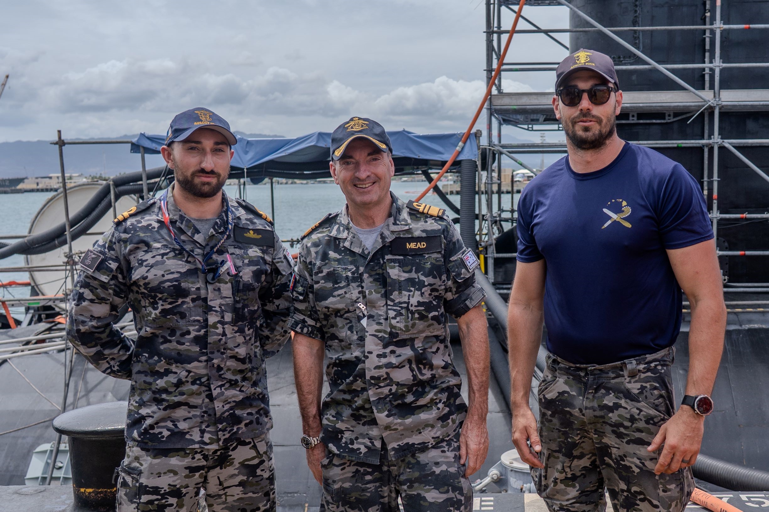 Royal Australian Navy VADM Jonathan Mead, Director-General of the Australian Submarine Agency (centre), visits with Royal Australian Navy divers assigned to Pearl Harbor during a tour of Pearl Harbor Naval Shipyard & Intermediate Maintenance Facility.