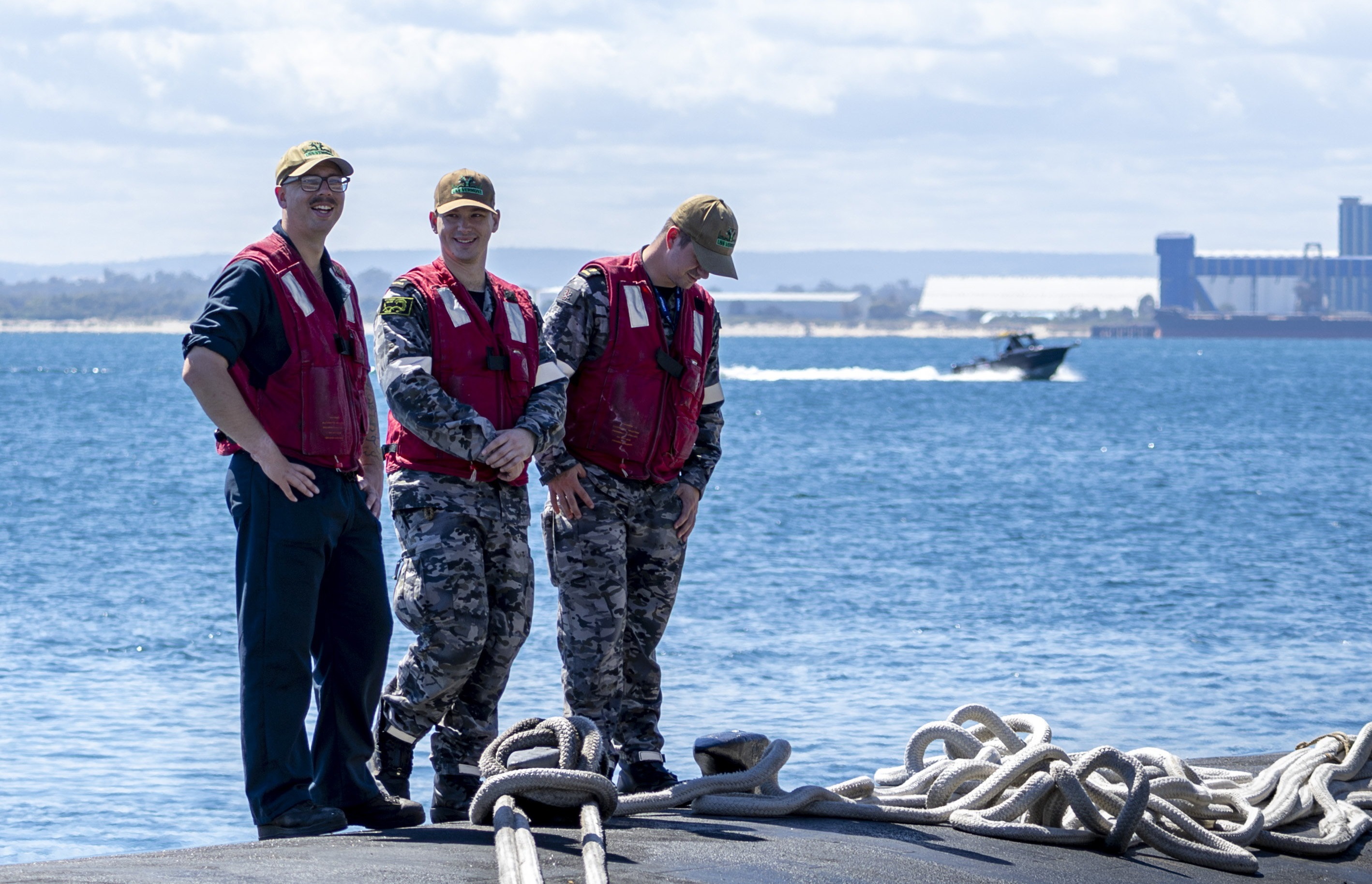 United States Navy and Royal Australian Navy submariners stand atop Virginia-class fast-attack submarine USS Vermont (SSN 792) as it prepares to depart HMAS Stirling in Western Australia after completing a scheduled Submarine Maintenance Period.