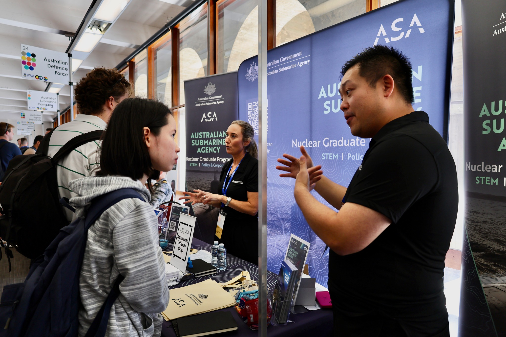 ASA staff chatting with job seekers about career opportunities in the nuclear-powered submarine enterprise at The University of Western Australia.