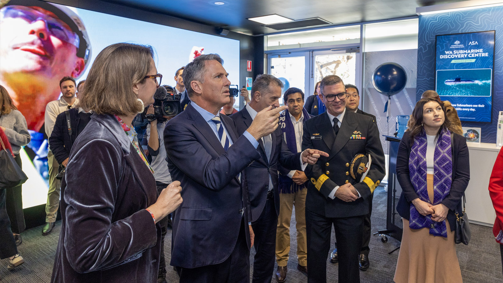 Deputy Prime Minister and Minister for Defence, the Hon. Richard Marles MP and A/g Assistant Director General Strategic Engagement and Policy Branch Australian Submarine Agency, Dr Kate O'Shaughnessy discuss an education display at the Submarine Discovery Centre.