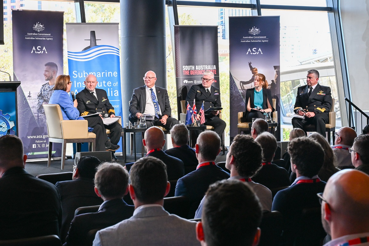 Panel discussion at an ASA industry event, with six speakers on stage and an audience in attendance.