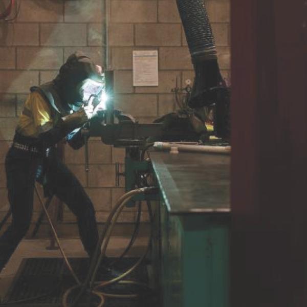 Worker welding submarine components