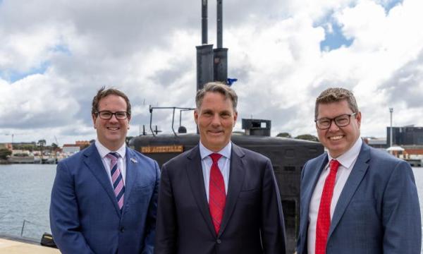 From left, Defence Personnel Minister Matt Keogh, Defence Minister Richard Marles and Defence Industry Minister Pat Conroy stand beside United States Navy submarine USS Asheville during a visit to HMAS Stirling, Western Australia. Photo: Leading Seaman Ernesto Sanchez