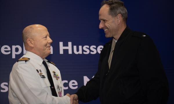 On behalf of the Secretary of the Navy, AUKUS Integration & Acquisition Director Rear Adm. Lincoln Reifsteck, right, presented Royal Australian Navy Captain Stephen Hussey with a Meritorious Service Award and medal during a Dec. 13, 2024