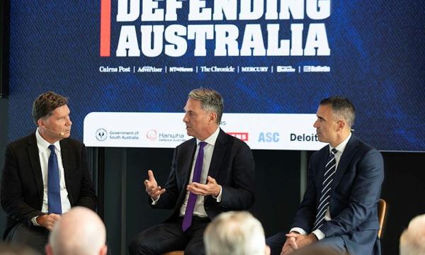 Deputy Prime Minister and Minister for Defence, The Hon. Richard Marles MP (centre), discusses defence industry opportunities with The Australian's Mr Cameron Stewart (left) and South Australian Premier, The Hon. Peter Malinauskas, at the Defending Australia forum held in Adelaide, South Australia.