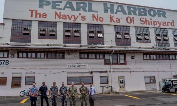 Royal Australian Navy VADM Jonathan Mead, Director-General of the Australian Submarine Agency (centre) and U.S. Navy Adm. William Houston, Director, Naval Nuclear Propulsion Program (centre right), pose for a group photo with Australian sailors, ASC personnel, and U.S. Navy staff outside Machine Shop 31 at Pearl Harbor Naval Shipyard & Intermediate Maintenance Facility. 